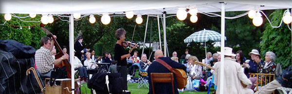 Band (including violin and chello) play in a marquee at the beautiful gardens at Gibberd Gardens